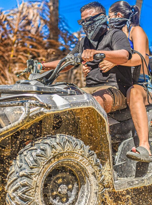 Tour group cooling off in a natural cenote during ATV adventure